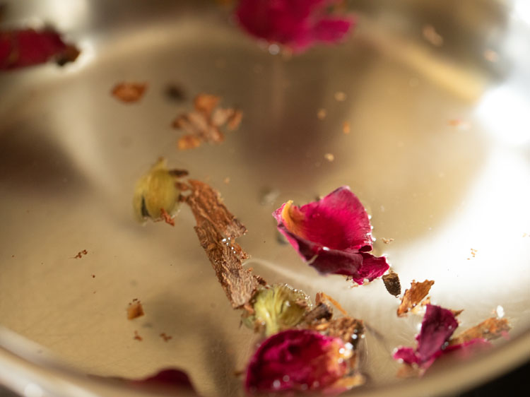 Dry rose petals are added to the water.