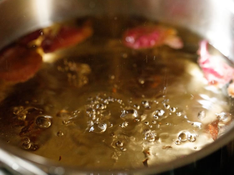 water and spices being simmered to a gentle boil in the pan.