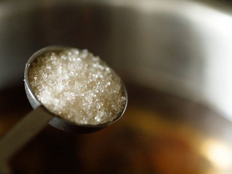 sugar being added in the pan.