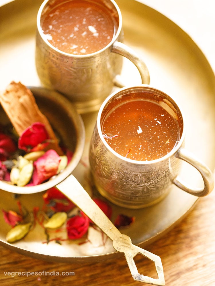 kashmiri kahwa served in two silver cups in a round brass plate