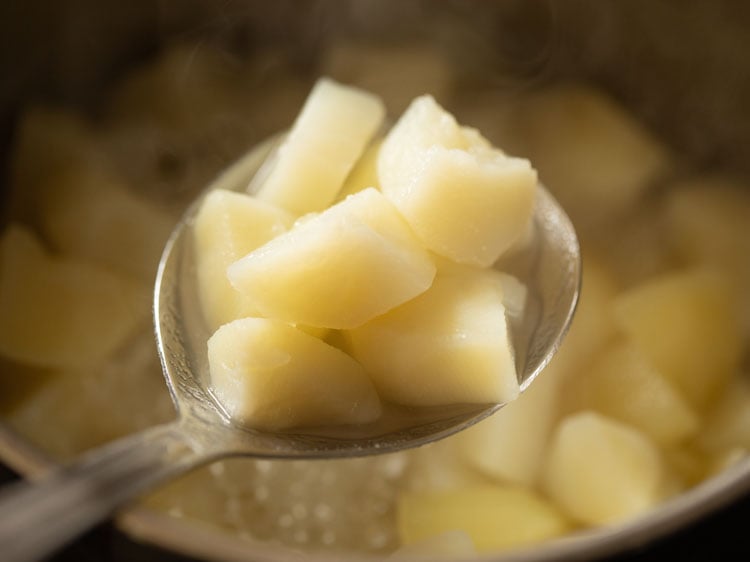 cooked potatoes in a spoon.