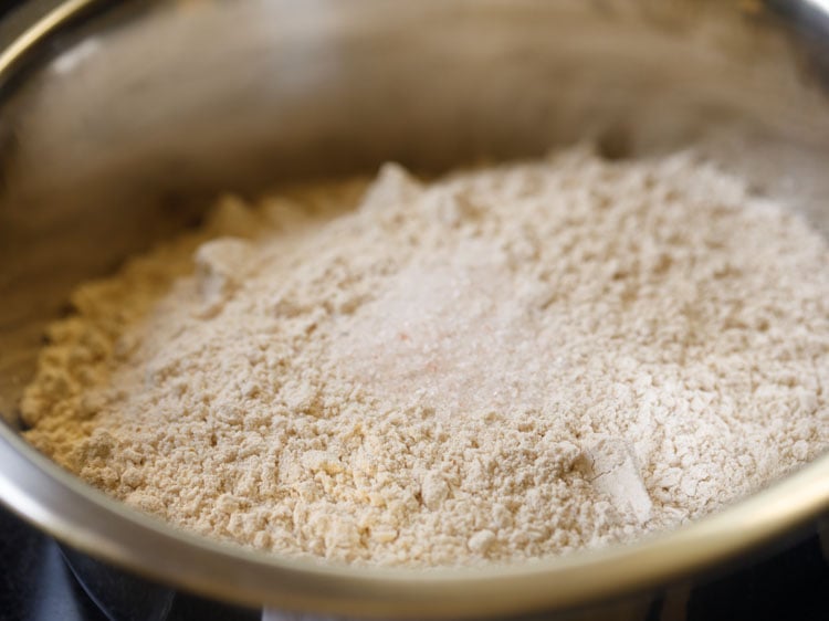 taking wheat flour and salt in a mixing bowl.