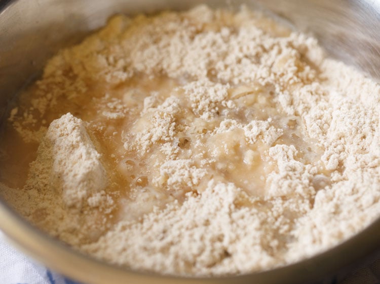 adding hot boiling water in parts to the flour.