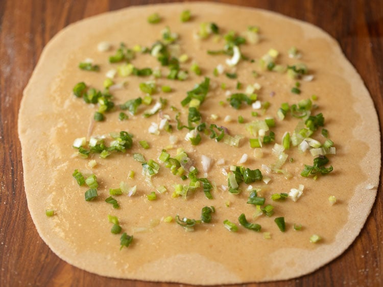 scallions sprinkled on the rolled dough.