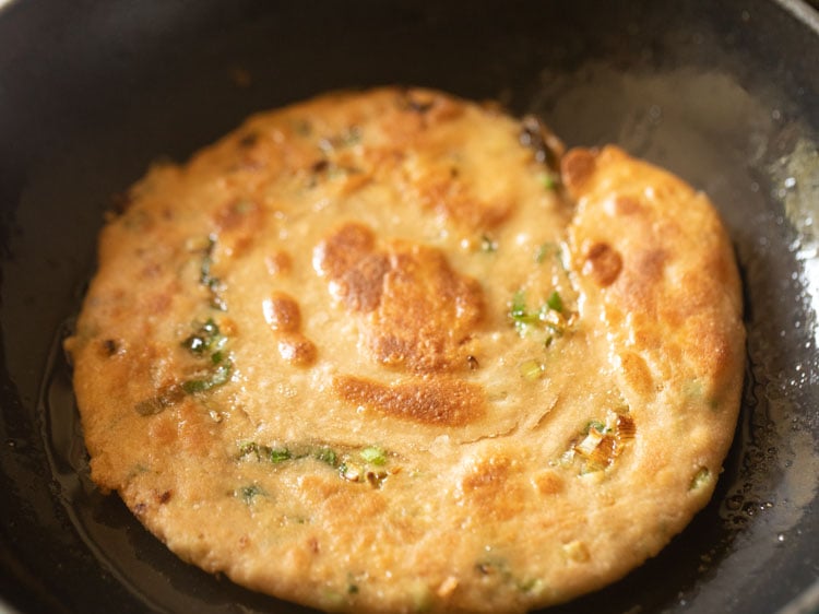 scallion pancake cooked flipped once or twice until deeply golden.