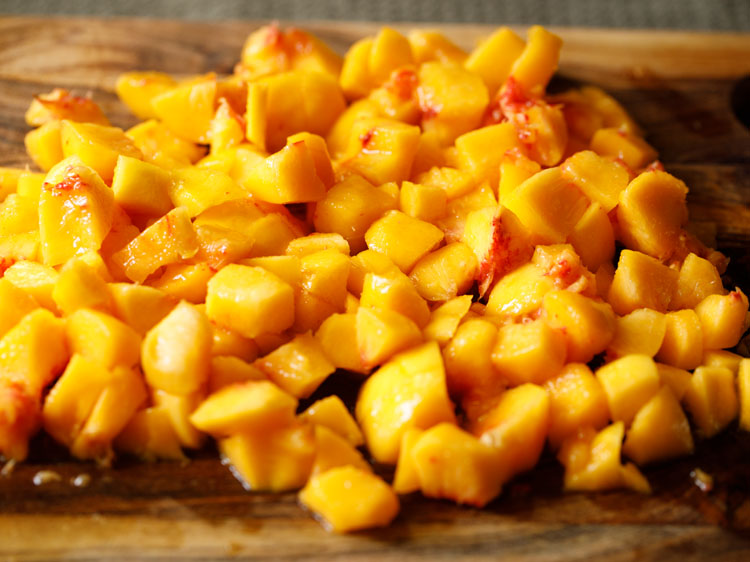 chopped peaches on a cutting board.