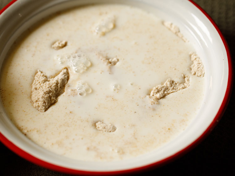 milk added to bowl with flour.