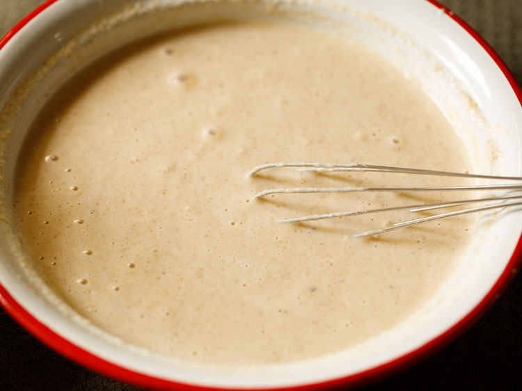 whisking cobbler batter until it is thin and runny like pancake batter.