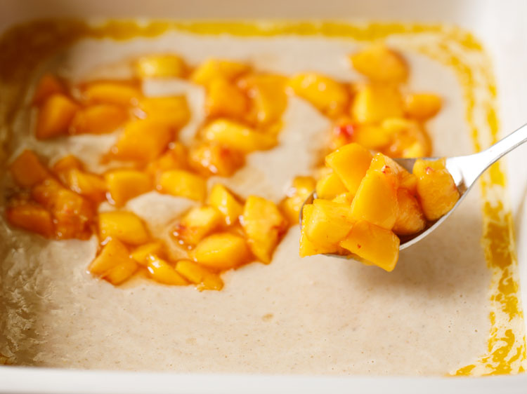 spooning the macerated peaches over the batter as evenly as possible.