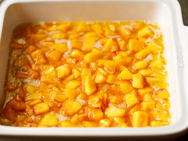 the peaches have been laid all over the batter.