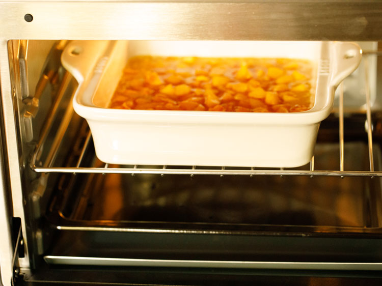 baking the peach cobbler in the oven.