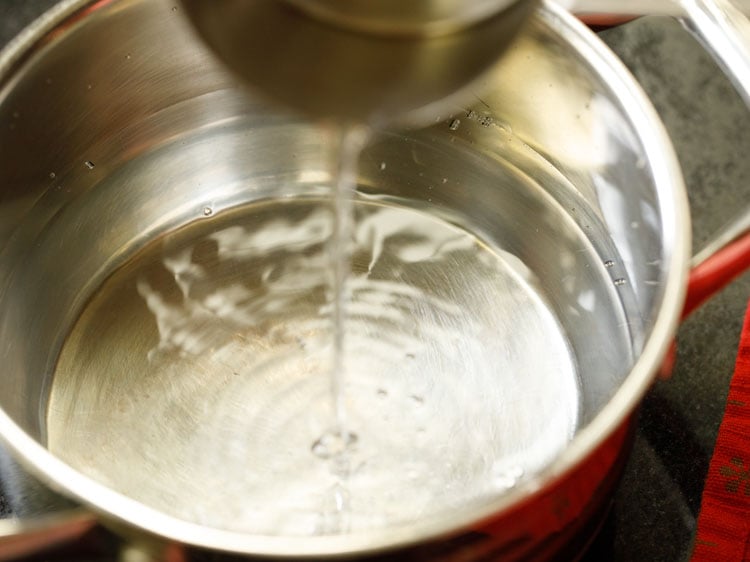 pouring water in a pan.