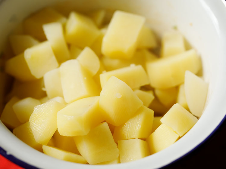 potatoes added to the bowl with the dressing. 