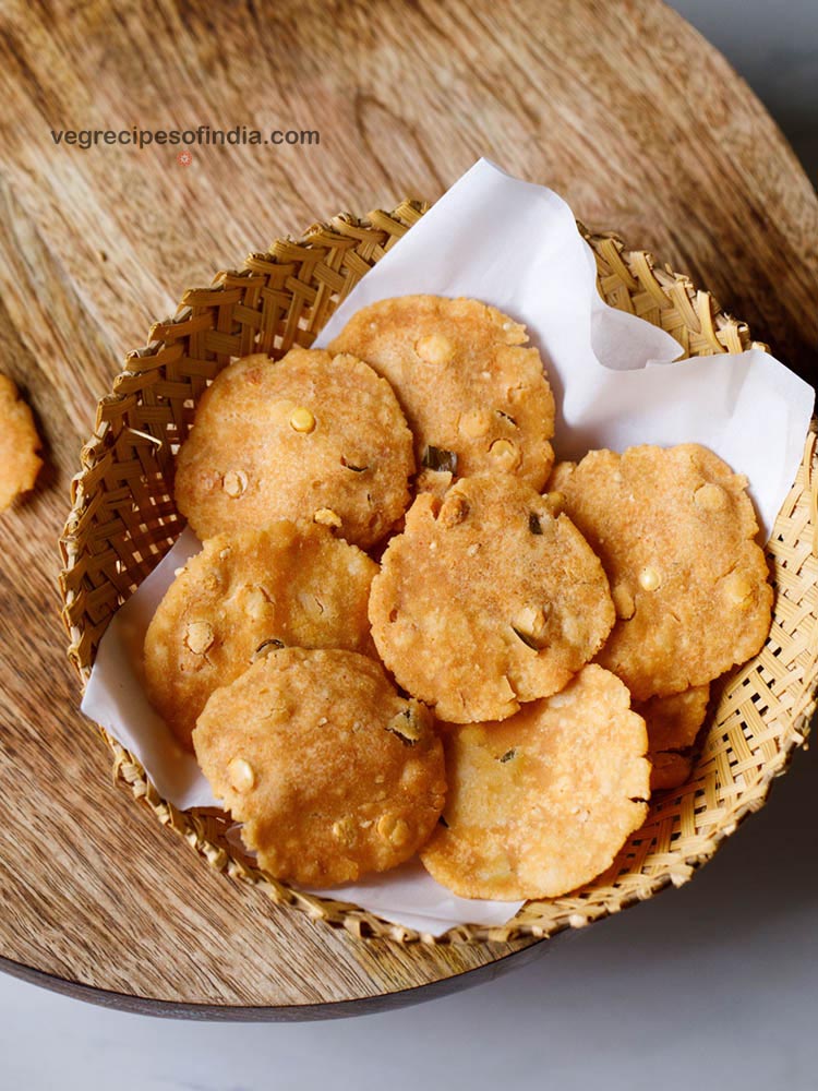 thattai placed on parchment paper in a cane bowl.