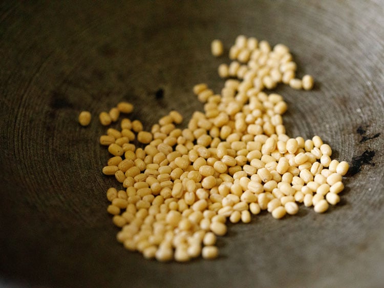 roasting urad dal in pan for thattai recipe. 