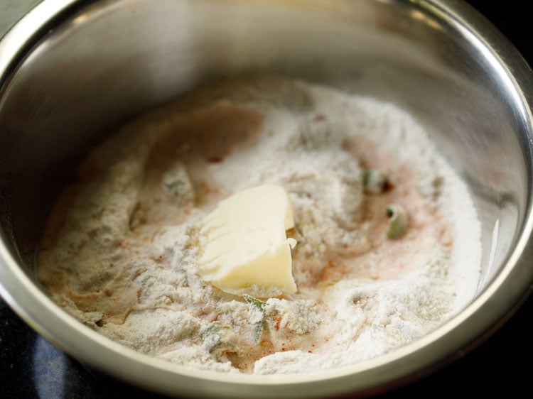 adding some water and butter to the flour mixture. 