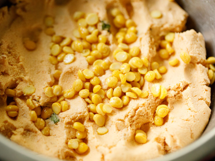 drained soaked chana dal added to the flour mixture. 