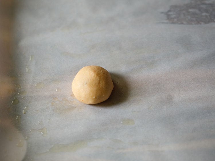 dough ball placed on the greased parchment paper. 