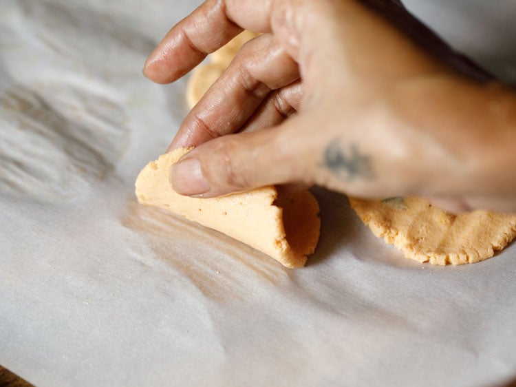 lifting the thattai from the parchment paper. 