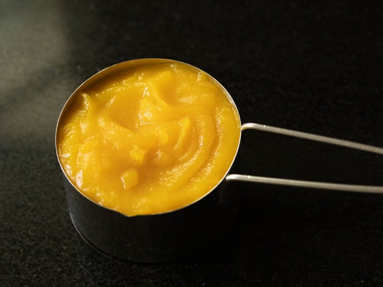 pumpkin puree in a measuring cup.