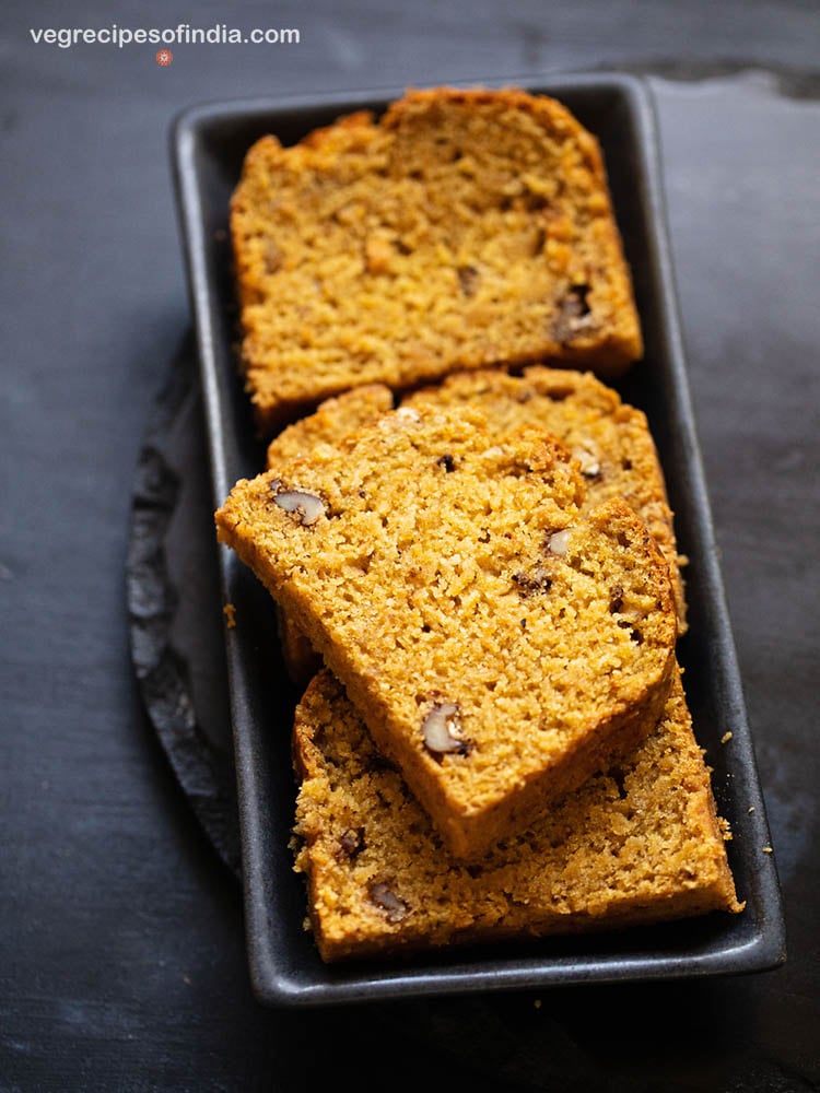 pumpkin bread slices on a black tray.