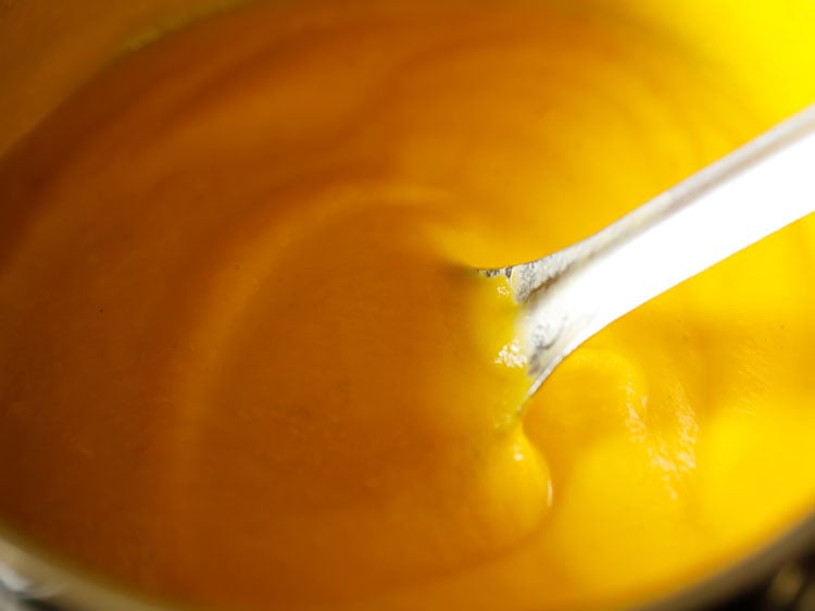 simmering carrot soup on stove-top till it becomes hot