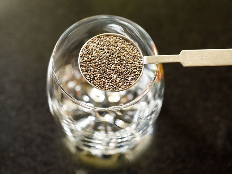 adding chia seeds in a glass.