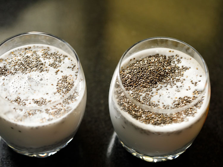 Coconut milk is added to the glass with chia seeds.