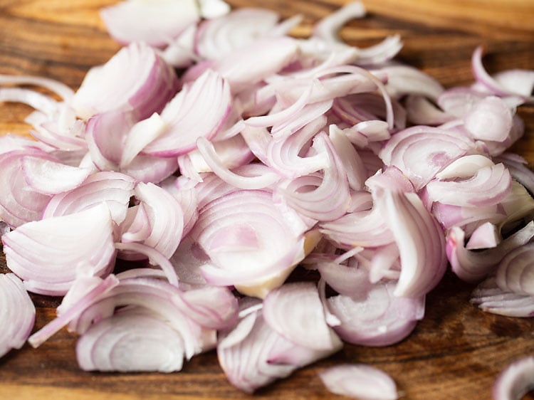 sliced onions on a chopping board.