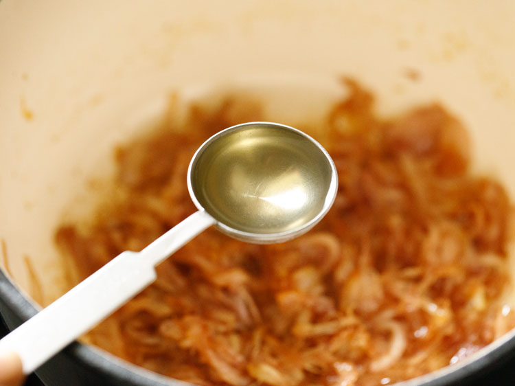 dry white wine being added to the caramelized onions.