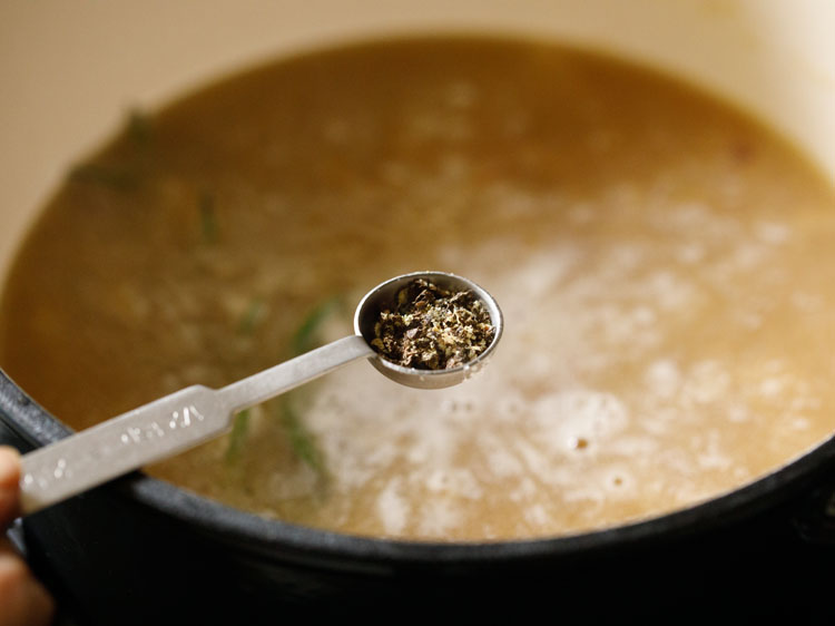 seasoning with crushed black pepper.