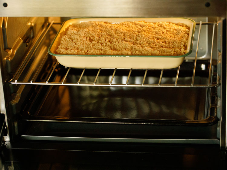 apple crumble getting baked in a preheated oven