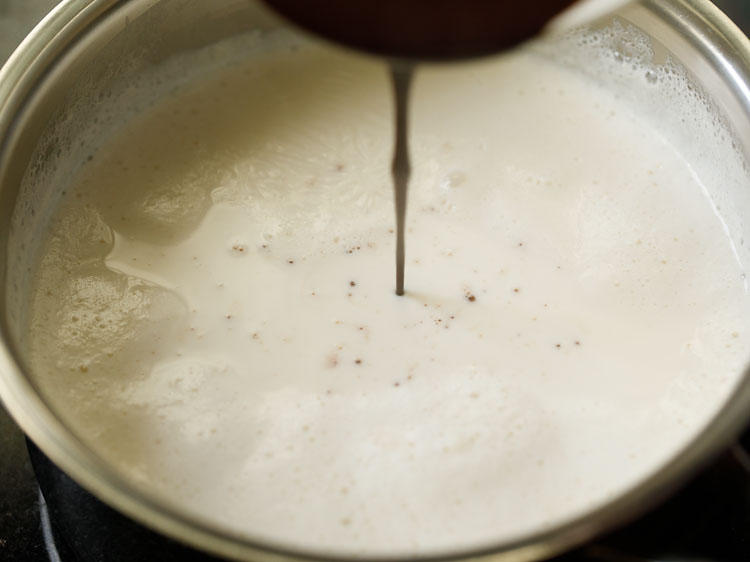 adding melted chocolate in hot milk