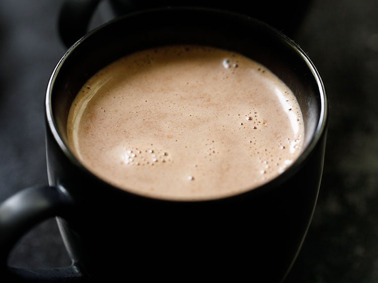 hot chocolate poured in a black cup