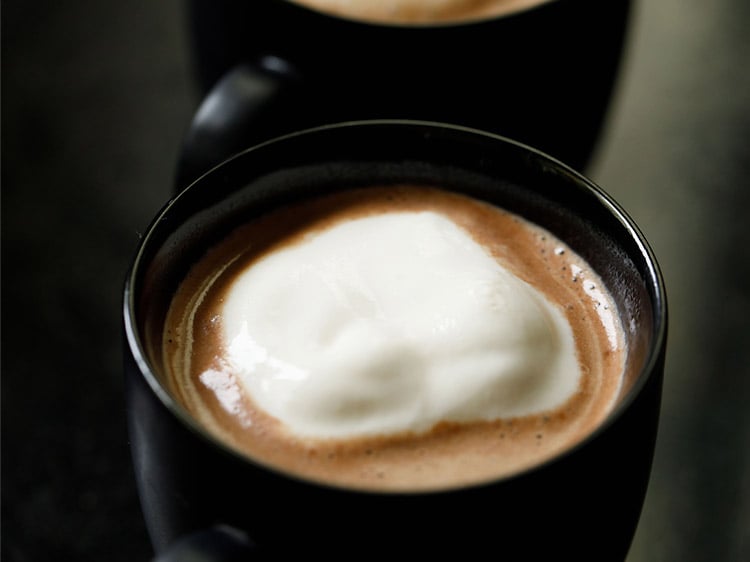 topping hot chocolate with whipped cream