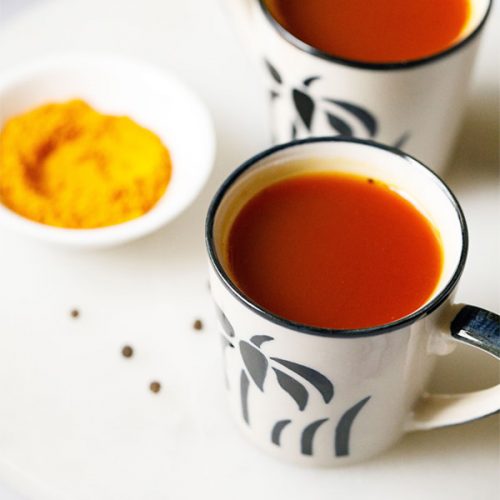 turmeric tea in black and white ceramic cups.