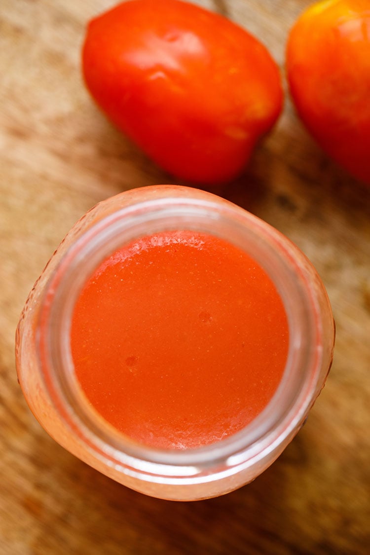 top shot of tomato puree in a glass jar.
