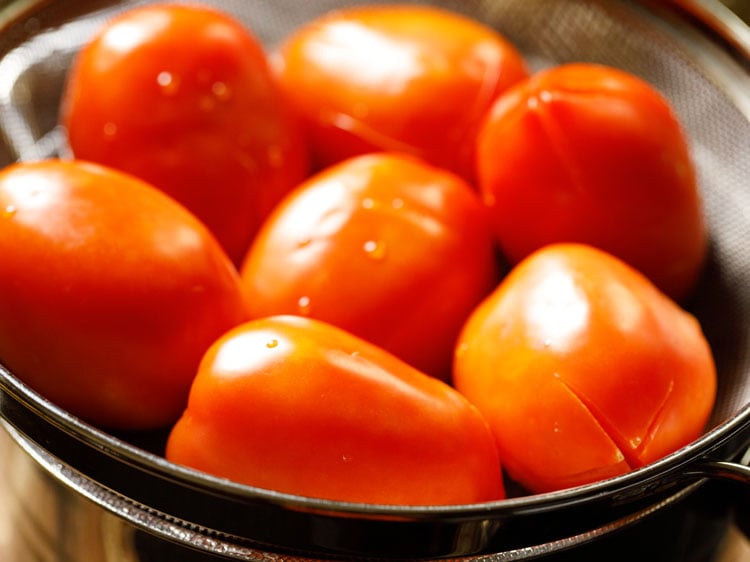 straining the tomatoes.