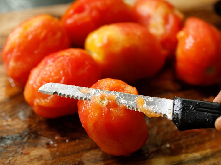 slicing the top eye part off the tomatoes.