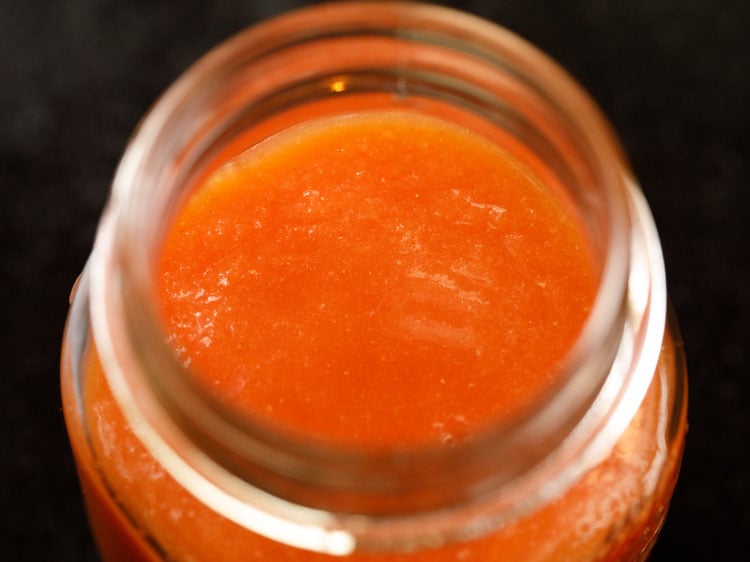 tomato puree poured in a clean sterilized jar.