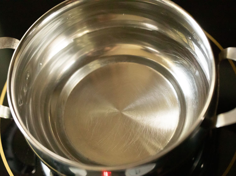 Water in a pan to make turmeric tea recipe.