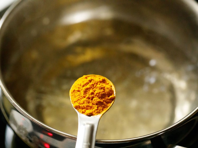 adding ground turmeric powder.