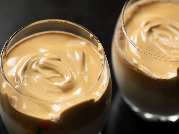 glasses topped with the with foamy and creamy whipped coffee.