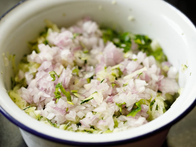 chopped onions added, garlic, parsley and celery added to the bowl.