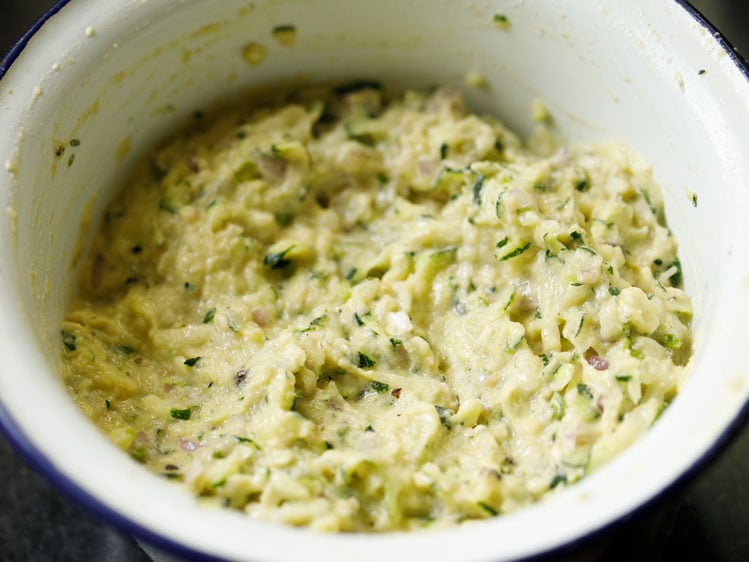 zucchini mixed to a batter in the bowl.