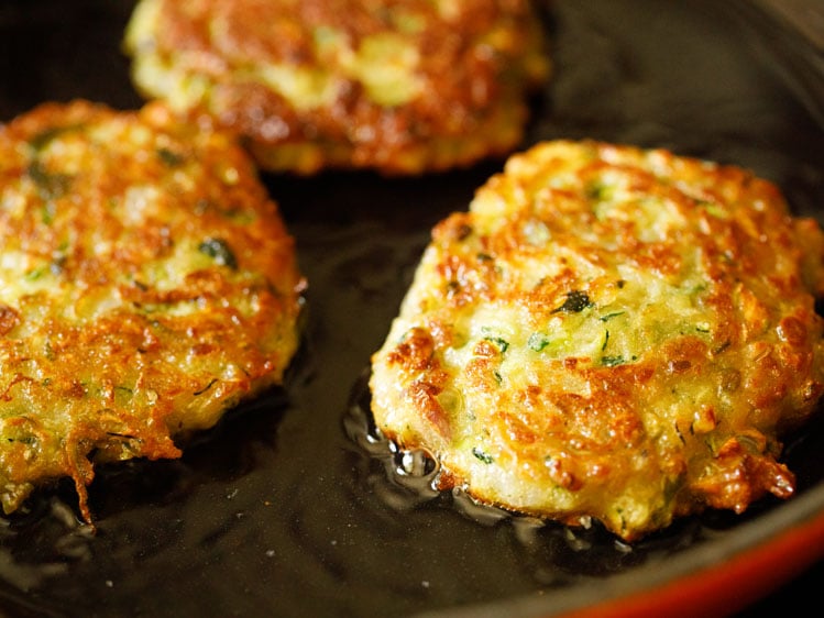 zucchini fritters cooked till both sides are golden and crisp.