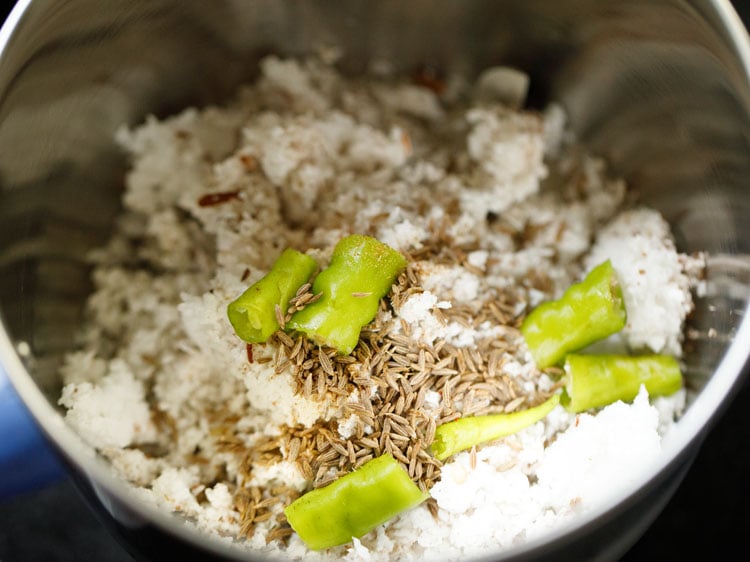 fresh coconut, green chilies and cumin seeds in a spice grinder to make coconut paste for kerala moru curry recipe