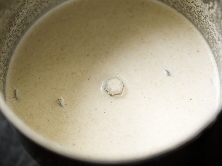 coconut paste in a spice grinder for making moru curry or pulissery recipe