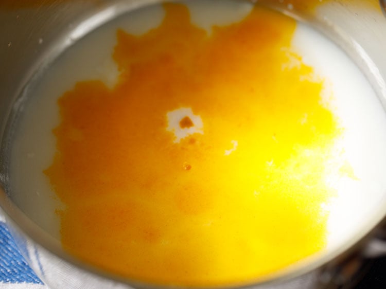 water and turmeric added to curd