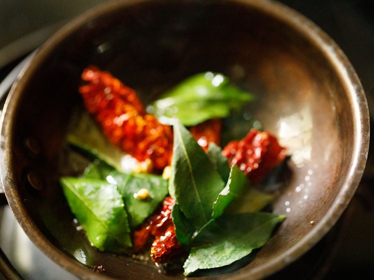 methi leaves and chilies in small sauté pan for making pulissery